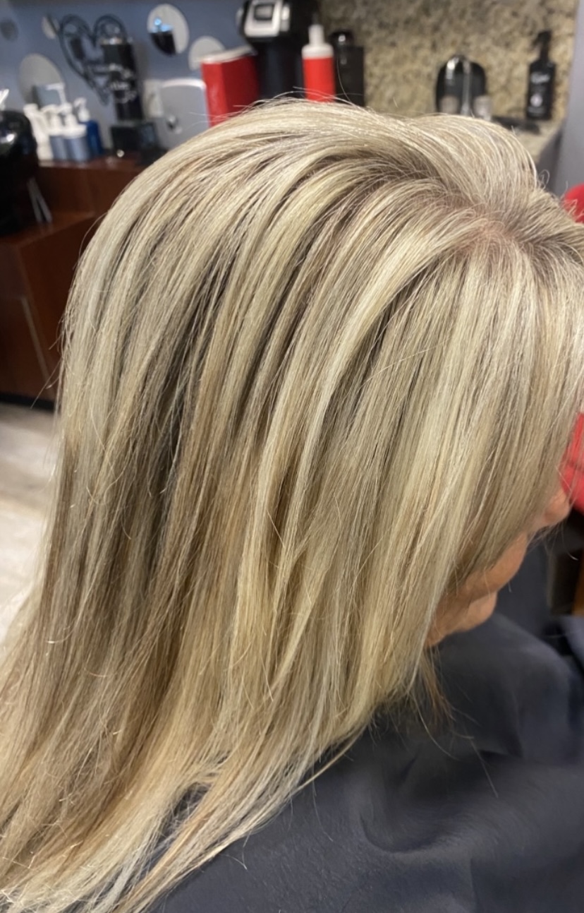 Glossy dimensional blonde blowout with soft root melt